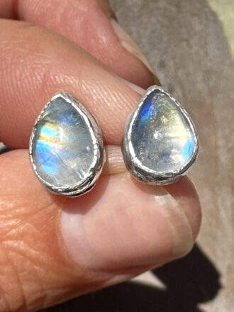 Super glowy rainbow moonstone stud earrings have rustic textures.